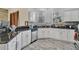 Charming kitchen featuring granite countertops, stainless steel appliances, ample cabinet space, and stylish tiled floors at 8614 Miramar Terrace Cir, Temple Terrace, FL 33637