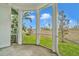 Screened porch overlooking a verdant backyard with lush greenery and a privacy wall at 8614 Miramar Terrace Cir, Temple Terrace, FL 33637