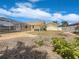 Backyard view with screened-in pool area, lush landscaping, and sunny sky at 111 Englewood Garden Ct, Englewood, FL 34223