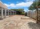 Brick patio outside of screened in pool area with manicured landscaping at 111 Englewood Garden Ct, Englewood, FL 34223