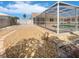 Spacious backyard with an enclosed pool area, gravel landscaping and fenced yard at 111 Englewood Garden Ct, Englewood, FL 34223
