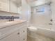 Bright bathroom featuring a shower-tub combo and updated vanity with a tiled backsplash at 111 Englewood Garden Ct, Englewood, FL 34223