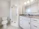 Modern bathroom with a glass-enclosed shower and vanity with granite counters at 111 Englewood Garden Ct, Englewood, FL 34223