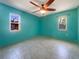 Bright bedroom featuring teal walls, ceiling fan, and tile floors at 111 Englewood Garden Ct, Englewood, FL 34223