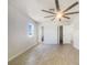 Bright bedroom featuring tile floors, a ceiling fan and a large window at 111 Englewood Garden Ct, Englewood, FL 34223