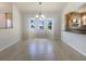 Open dining room with a bay window, chandelier and view of the kitchen at 111 Englewood Garden Ct, Englewood, FL 34223