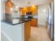 Modern kitchen with stainless steel appliances, wooden cabinets, and a center island at 111 Englewood Garden Ct, Englewood, FL 34223