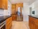 Bright kitchen features wooden cabinets, stainless steel appliances, and black countertops at 111 Englewood Garden Ct, Englewood, FL 34223