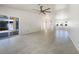 Spacious living room featuring neutral tile flooring and natural light from the sliding glass doors at 111 Englewood Garden Ct, Englewood, FL 34223