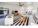 Bright and airy living room with modern furnishings and stylish decor, leading to a dining area at 111 Englewood Garden Ct, Englewood, FL 34223