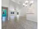 Open-concept living room featuring high ceilings, tile floors and access to other rooms at 111 Englewood Garden Ct, Englewood, FL 34223
