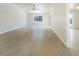 Bright living room with tile floors and large windows, flowing to screened outdoor space at 111 Englewood Garden Ct, Englewood, FL 34223