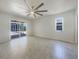Bright main bedroom featuring tile floors, a ceiling fan and sliding doors to the lanai at 111 Englewood Garden Ct, Englewood, FL 34223