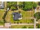 Aerial shot shows roof with solar panels, large yard, and driveway at 16805 Tobacco Rd, Lutz, FL 33558