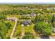 An aerial view of the beautiful property with a well-manicured lawn and mature trees at 16805 Tobacco Rd, Lutz, FL 33558