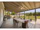 Large, covered back porch perfect for entertaining with a table and chairs, and a view to a green backyard at 16805 Tobacco Rd, Lutz, FL 33558
