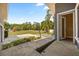 View from the back porch to the large backyard, basketball court, and mature trees at 16805 Tobacco Rd, Lutz, FL 33558
