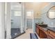 Detailed bathroom including blue tiling, a walk-in shower, and a vanity area at 16805 Tobacco Rd, Lutz, FL 33558