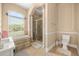 Elegant bathroom features a soaking tub, marble details, a walk-in shower, and a separate toilet area at 16805 Tobacco Rd, Lutz, FL 33558