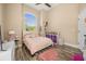 Bedroom featuring a cream color paint and wood floors at 16805 Tobacco Rd, Lutz, FL 33558