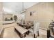 Elegant dining area with a modern chandelier, decorative wall trim, and an open flow to the kitchen at 16805 Tobacco Rd, Lutz, FL 33558