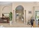 Hallway with decorative pillars, tile flooring, and views into other rooms at 16805 Tobacco Rd, Lutz, FL 33558