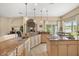 Open kitchen featuring granite countertops, an island cooktop, pendant lighting, and outdoor access at 16805 Tobacco Rd, Lutz, FL 33558