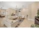 Bright living room with tile floors, neutral paint, stylish furniture, and a modern chandelier at 16805 Tobacco Rd, Lutz, FL 33558