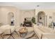 Inviting living room with travertine floors, a fireplace, comfortable seating, and views of adjacent rooms at 16805 Tobacco Rd, Lutz, FL 33558
