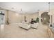 Open-concept living room boasts tile floors, a large chandelier, and neutral walls at 16805 Tobacco Rd, Lutz, FL 33558