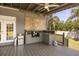 Outdoor kitchen equipped with a sink, prep area, and mini fridge, perfect for outdoor entertaining at 16805 Tobacco Rd, Lutz, FL 33558