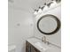 Bathroom featuring a vanity with marble countertop, framed mirror, and modern lighting at 2486 Caring Way # 17A, Port Charlotte, FL 33952
