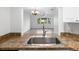 View from kitchen sink to living room featuring tile floors, natural light, and an open floor plan at 2486 Caring Way # 17A, Port Charlotte, FL 33952