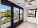 Enclosed lanai with tiled floor, ceiling fan, and a view of the lake at 2486 Caring Way # 17A, Port Charlotte, FL 33952