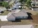 An aerial rear view showcasing the property's new roof, clean yard, and neighborhood at 3105 Lockwood St, Port Charlotte, FL 33952
