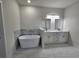 Luxurious bathroom featuring a freestanding tub and a double sink vanity with modern fixtures at 3105 Lockwood St, Port Charlotte, FL 33952