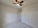 Bedroom with tile floors, ceiling fan, closet and natural light from the window at 3105 Lockwood St, Port Charlotte, FL 33952