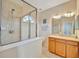 Well-lit bathroom features glass-enclosed shower, tile floor, and wooden vanity at 4062 Overture Cir # 4062, Bradenton, FL 34209