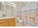 Charming bathroom with beach themed shower curtain and a wood vanity offers a pleasant and functional space at 4062 Overture Cir # 4062, Bradenton, FL 34209