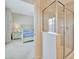 Bathroom view through doorway, featuring glass enclosed shower and the bedroom beyond at 4062 Overture Cir # 4062, Bradenton, FL 34209