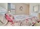 Inviting bedroom features a bright window, floral patterned bedding, and neutral wall color, creating a relaxing retreat at 4062 Overture Cir # 4062, Bradenton, FL 34209