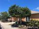 A warm building exterior with a stone facade, lush landscaping, and well-maintained sidewalks at 4062 Overture Cir # 4062, Bradenton, FL 34209