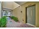 Inviting front entrance with brick pavers, well-maintained garden bed and covered walkway at 4062 Overture Cir # 4062, Bradenton, FL 34209