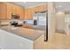 Spacious kitchen featuring a large stainless steel refrigerator and a breakfast bar at 4062 Overture Cir # 4062, Bradenton, FL 34209