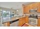 Open-concept kitchen with a view of the living area and access to the outdoor balcony at 4062 Overture Cir # 4062, Bradenton, FL 34209