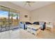 Comfortable living room with sliding glass doors to a screened balcony overlooking tropical foliage at 4062 Overture Cir # 4062, Bradenton, FL 34209