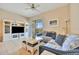 Cozy living room featuring a built-in entertainment center and sliding doors to the outdoor balcony at 4062 Overture Cir # 4062, Bradenton, FL 34209