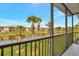 Screened balcony overlooking a tranquil pond, palm trees, and other townhomes at 4062 Overture Cir # 4062, Bradenton, FL 34209