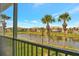 View from screened balcony of the tranquil pond and other townhomes with palm trees at 4062 Overture Cir # 4062, Bradenton, FL 34209