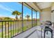Screened balcony with a view of the pond, palm trees, and neighborhood at 4062 Overture Cir # 4062, Bradenton, FL 34209